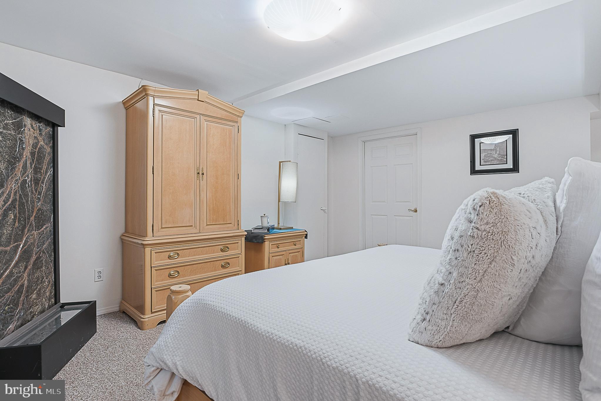 4542 Kinmount Road Lanham, MD 20706 - Photo 57 of 70 a spacious bedroom with a bed and a refrigerator
