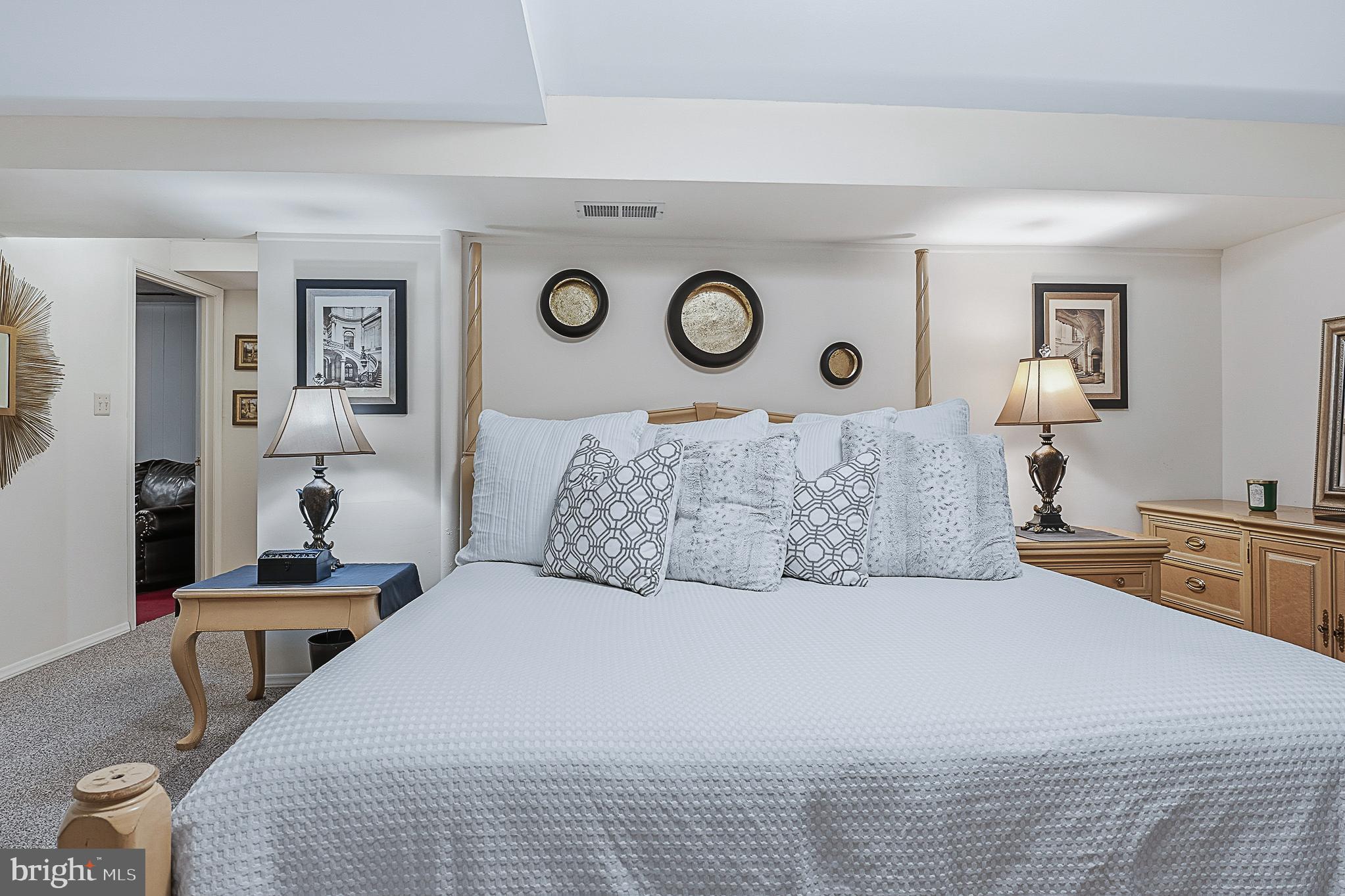 4542 Kinmount Road Lanham, MD 20706 - Photo 58 of 70 a bedroom with a bed and a lamp on dresser