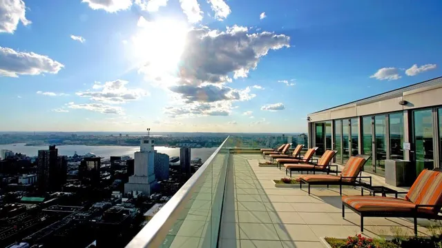 a terrace with outdoor seating and city view