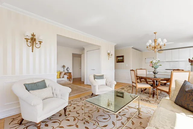 a living room with furniture and a chandelier