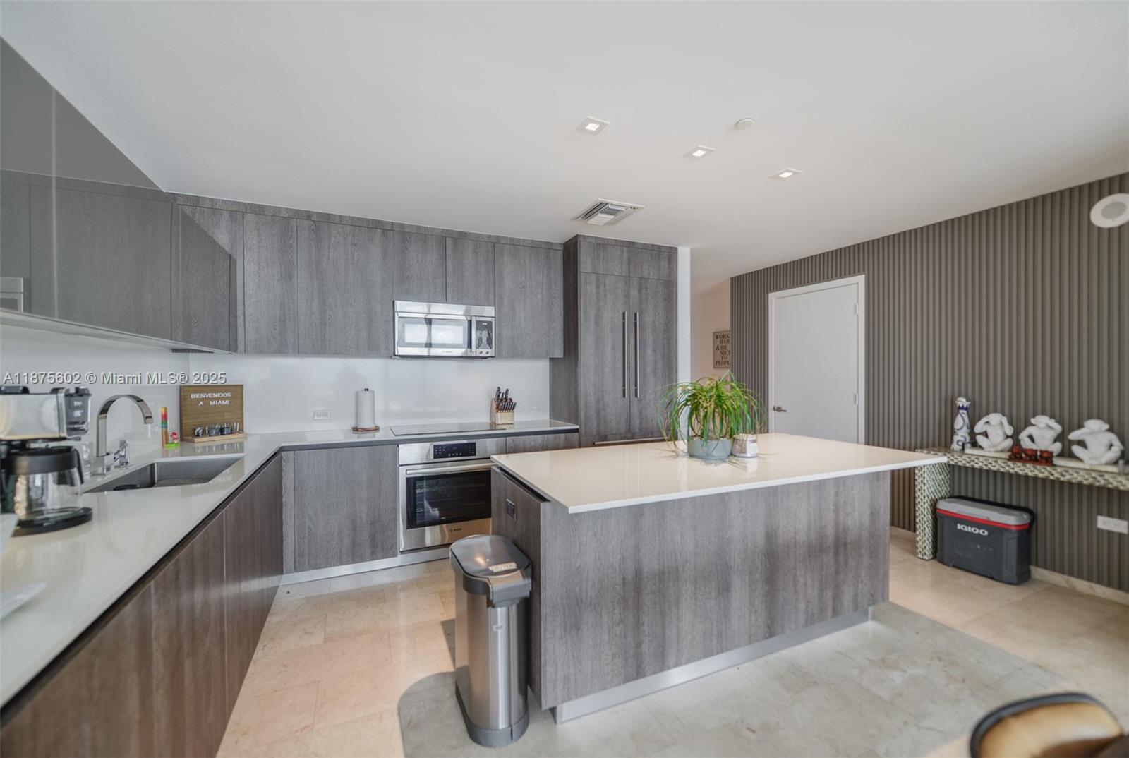 88 Southwest 7th Street, Unit 2204 Miami, FL 33130 - Photo 11 of 58 a kitchen with a stove a sink and a refrigerator