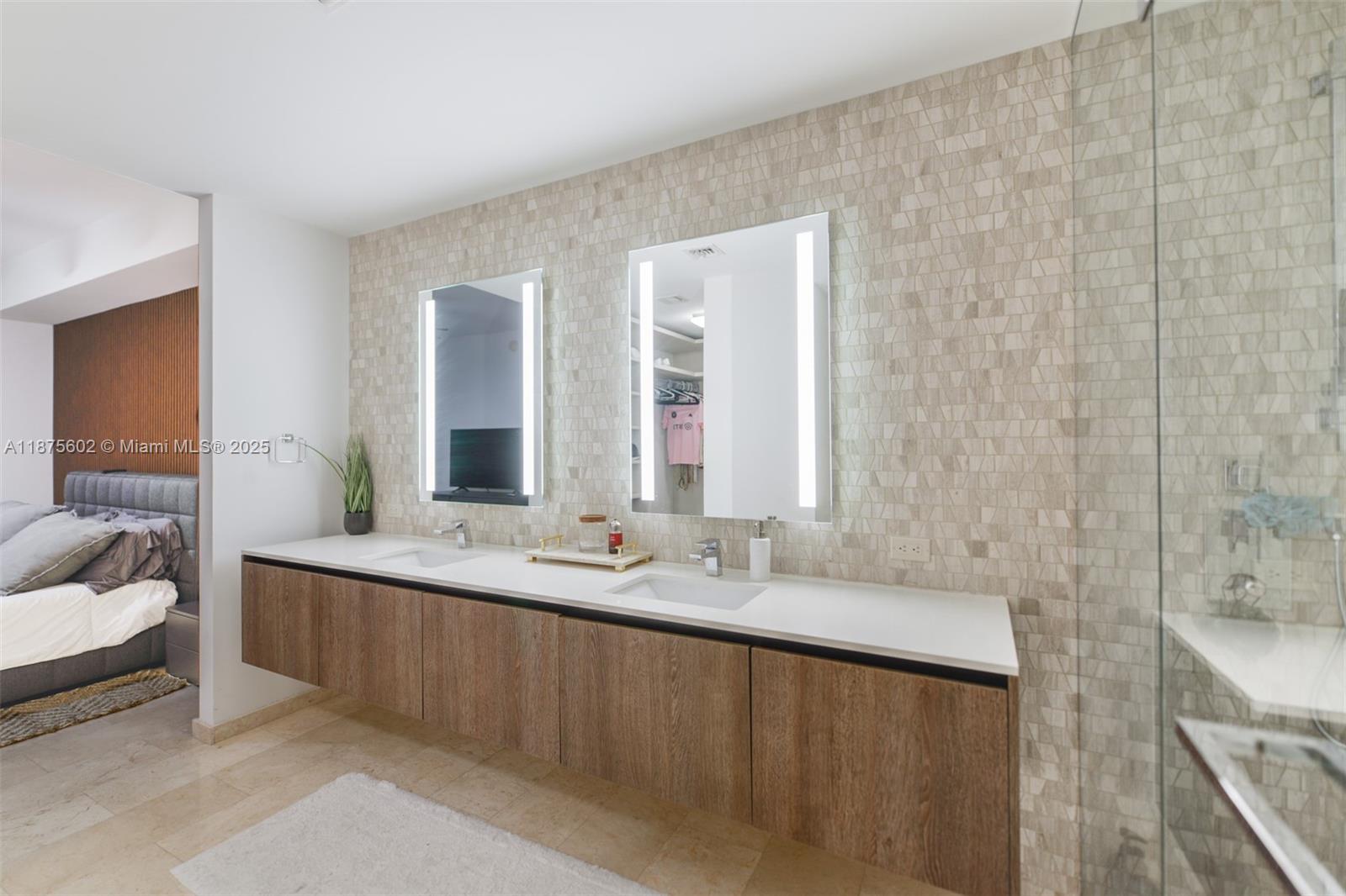 88 Southwest 7th Street, Unit 2204 Miami, FL 33130 - Photo 23 of 58 a bathroom with a double vanity sink and a mirror