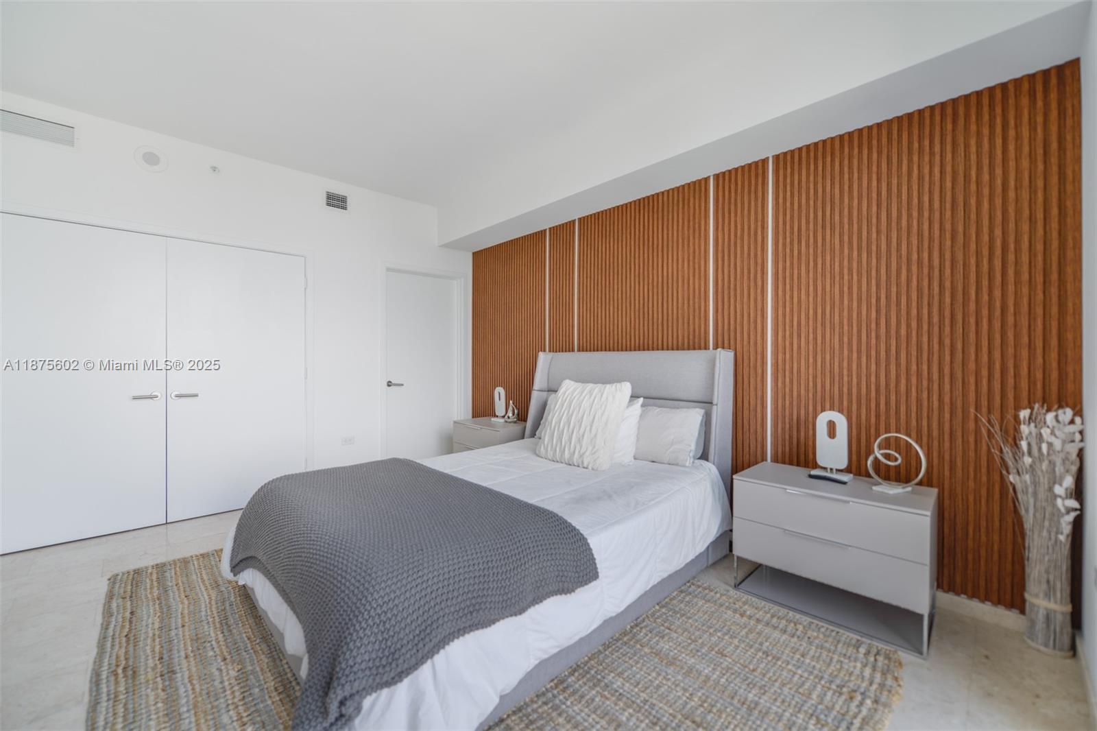 88 Southwest 7th Street, Unit 2204 Miami, FL 33130 - Photo 25 of 58 a bedroom with a bed and a couch