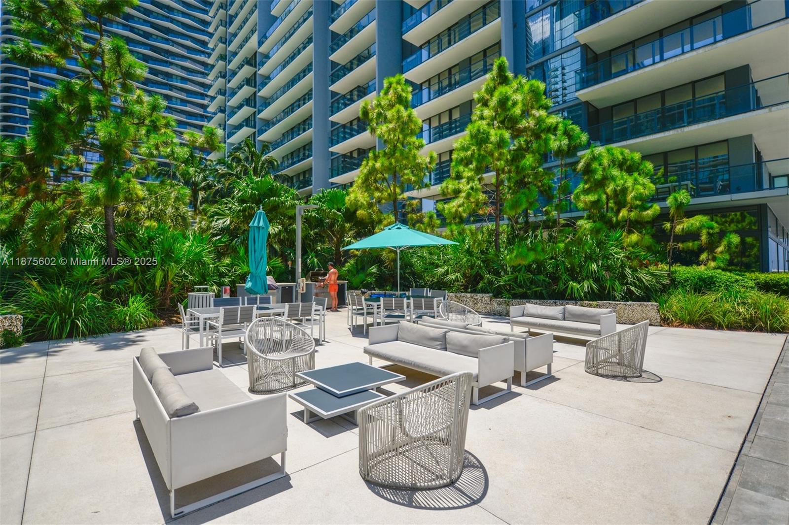 88 Southwest 7th Street, Unit 2204 Miami, FL 33130 - Photo 36 of 58 a view of a patio with couches table and chairs and potted plants