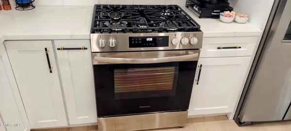 a close view of a stove and cabinets