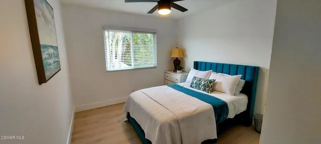 a bedroom with a bed and window