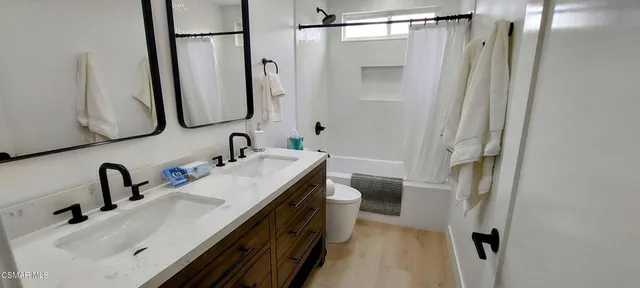 a bathroom with a double vanity sink and mirror