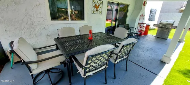 a view of backyard with a table and chairs