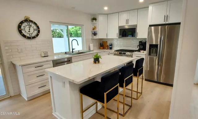 a kitchen with a stove a refrigerator and a sink