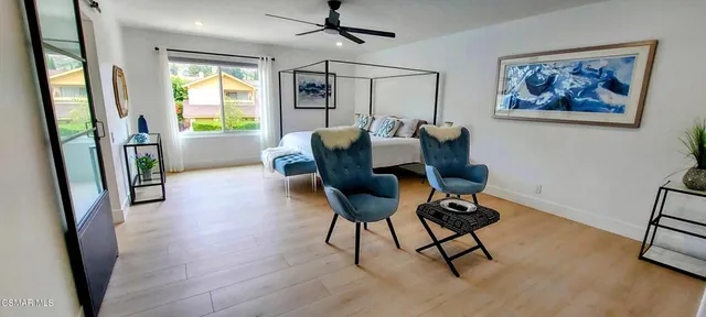 a view of a livingroom with furniture and a window