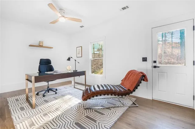 a view of a hallway with wooden floor and entryway