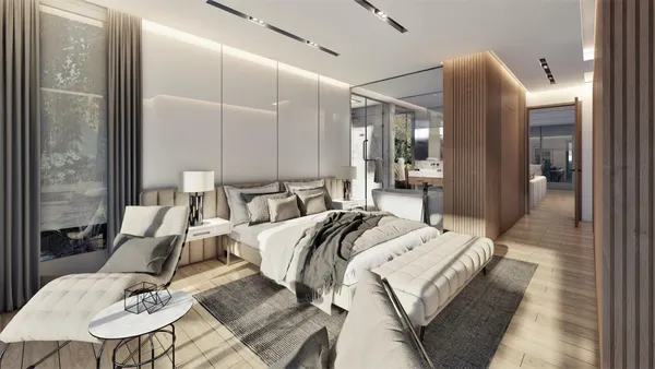 a room with a bed a mirror and windows