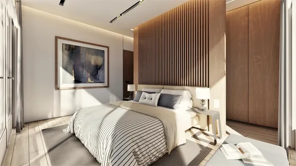 a bedroom with a bed and wooden floor