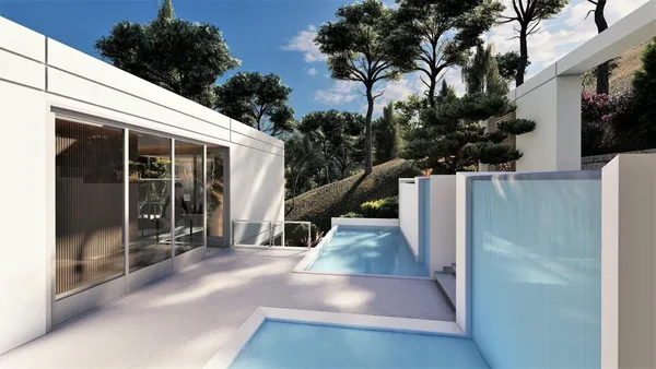 a view of a white house with large windows and a small yard