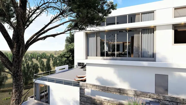 an aerial view of a house with a yard