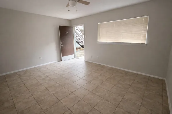 an empty room with windows and closet