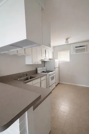 a kitchen with stainless steel appliances white cabinets and a sink
