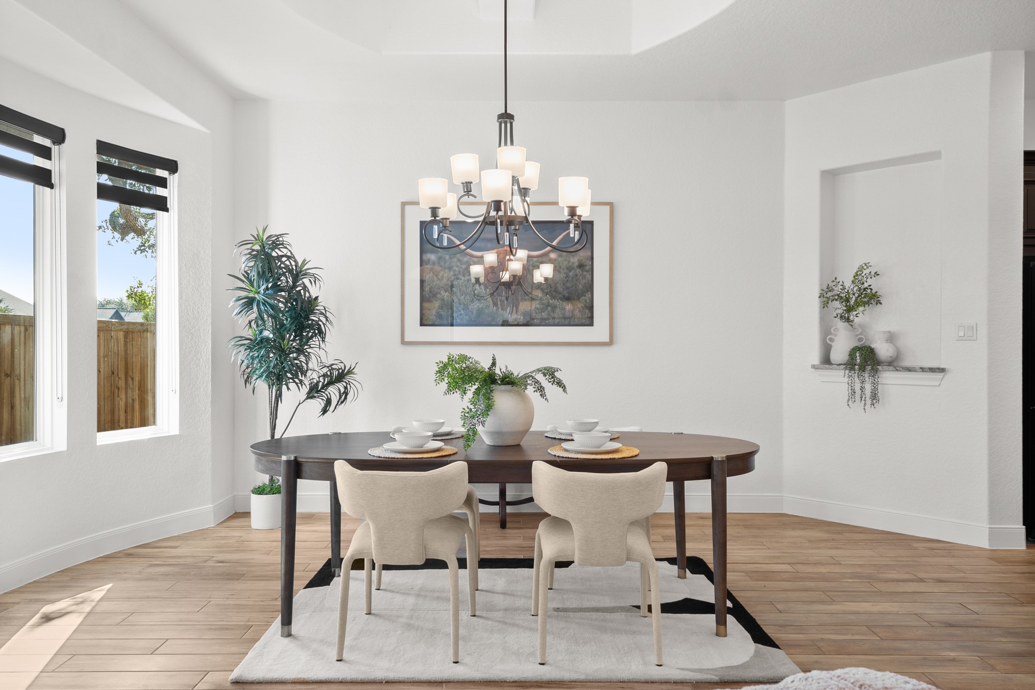 128 Hiram Cook Blanco, TX 78606 - Photo 9 of 40 Dining area featuring wood-finish flooring, a tray ceiling, and a multi-light chandelier