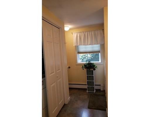12 Parlee Road Chelmsford, MA 01824 - Photo 24 of 31 a view of a hallway with wooden floor and a bathroom