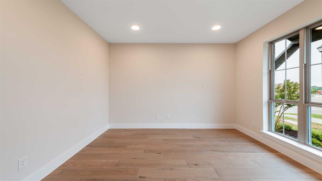854 Stoney Bridge Way Lavon, TX 75166 - Photo 10 of 36 an empty room with wooden floor and windows