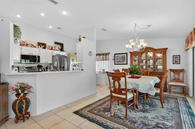 a view of a dining room with furniture and chandelier