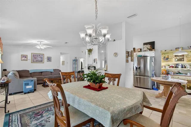 a view of a dining room with furniture and a chandelier