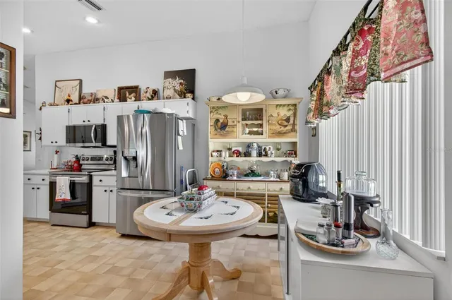 a kitchen with stainless steel appliances kitchen island granite countertop a sink and cabinets