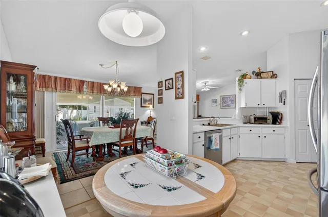 a large kitchen with a table and chairs