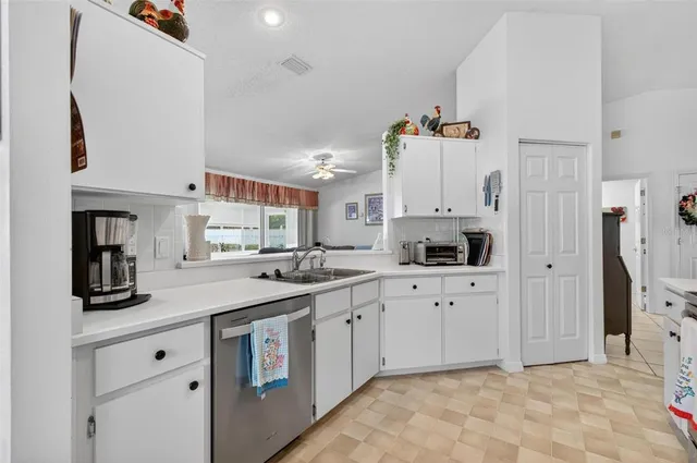 a kitchen with cabinets and window