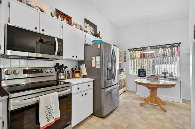 a kitchen with stainless steel appliances a stove microwave and refrigerator