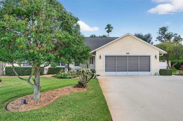 a front view of a house with a yard and trees