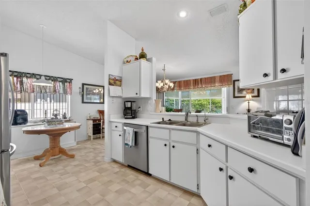 a kitchen with sink cabinets and window