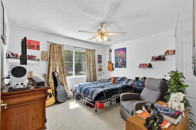 a bedroom with furniture and a large window