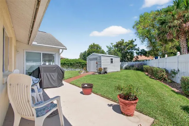a view of a porch with furniture and garden