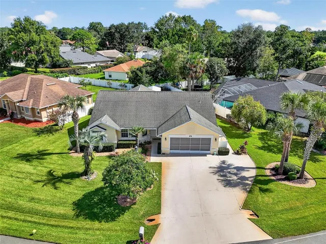 an aerial view of a house with yard swimming pool and outdoor seating