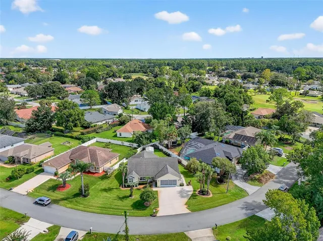 an aerial view of residential houses with outdoor space and street view