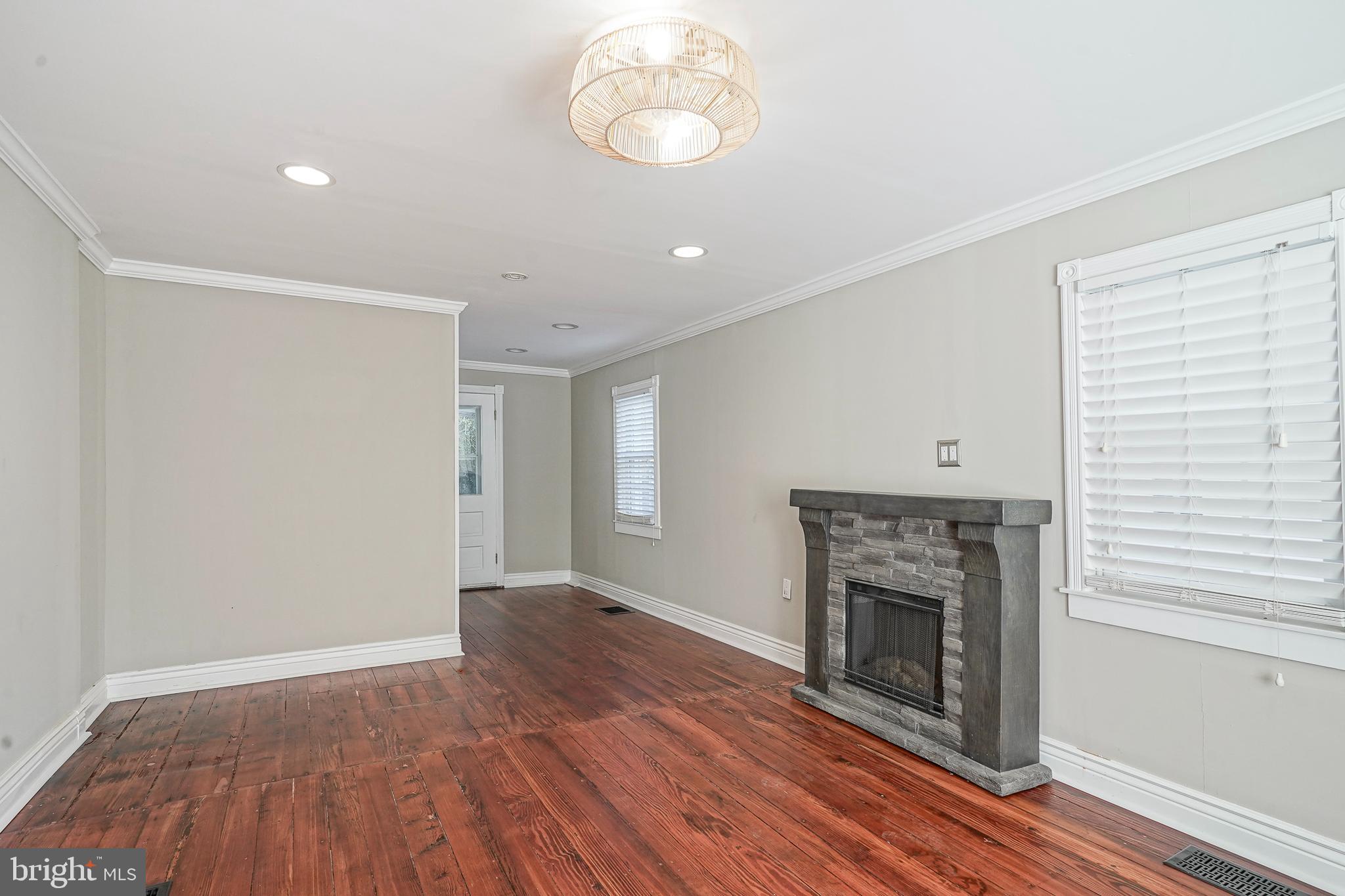 53 Branch Street Medford, NJ 08055 - Photo 12 of 41 an empty room with wooden floor a fireplace and windows
