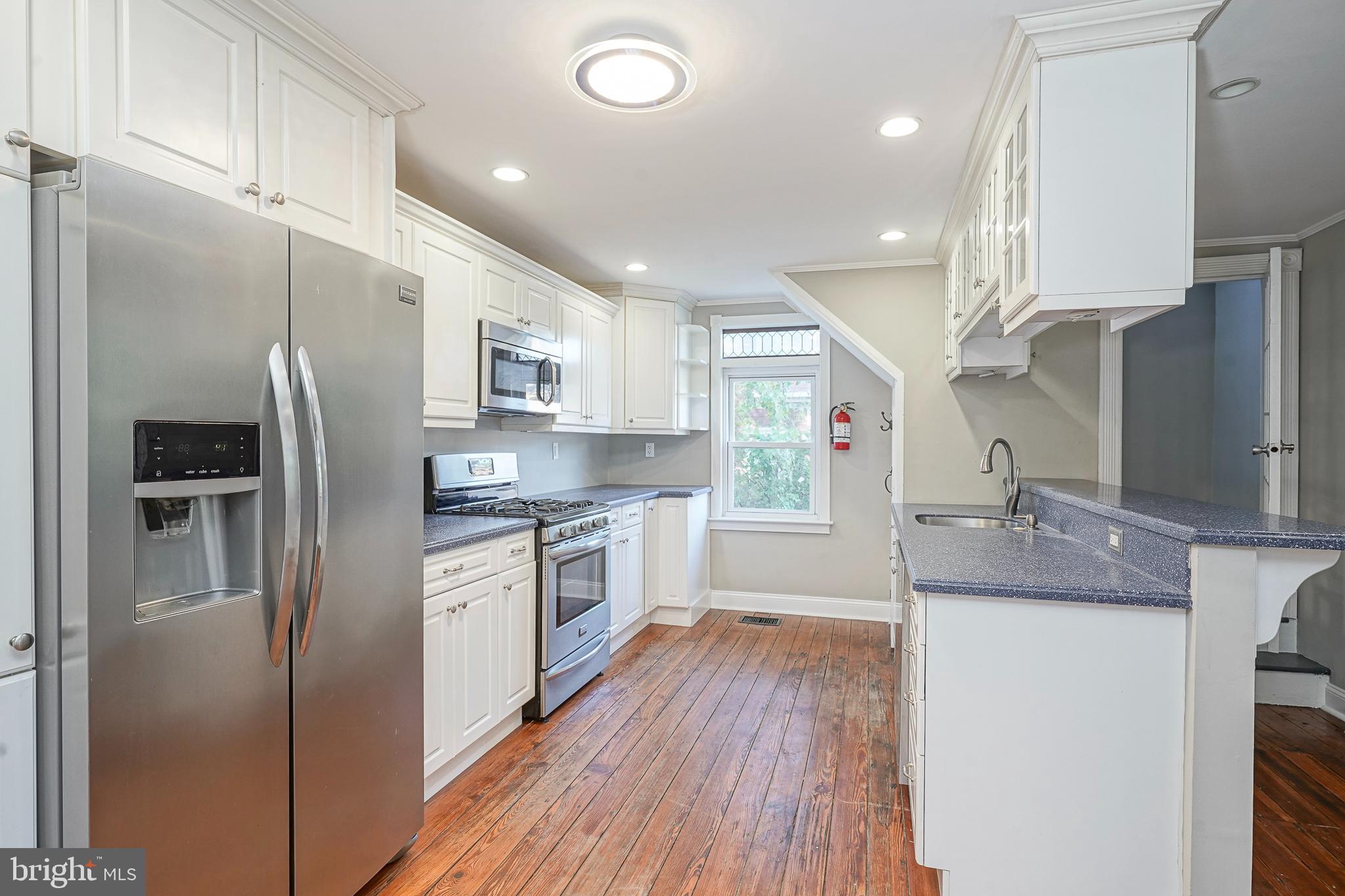 53 Branch Street Medford, NJ 08055 - Photo 15 of 41 a kitchen with stainless steel appliances granite countertop a refrigerator a sink a stove and white cabinets with wooden floor