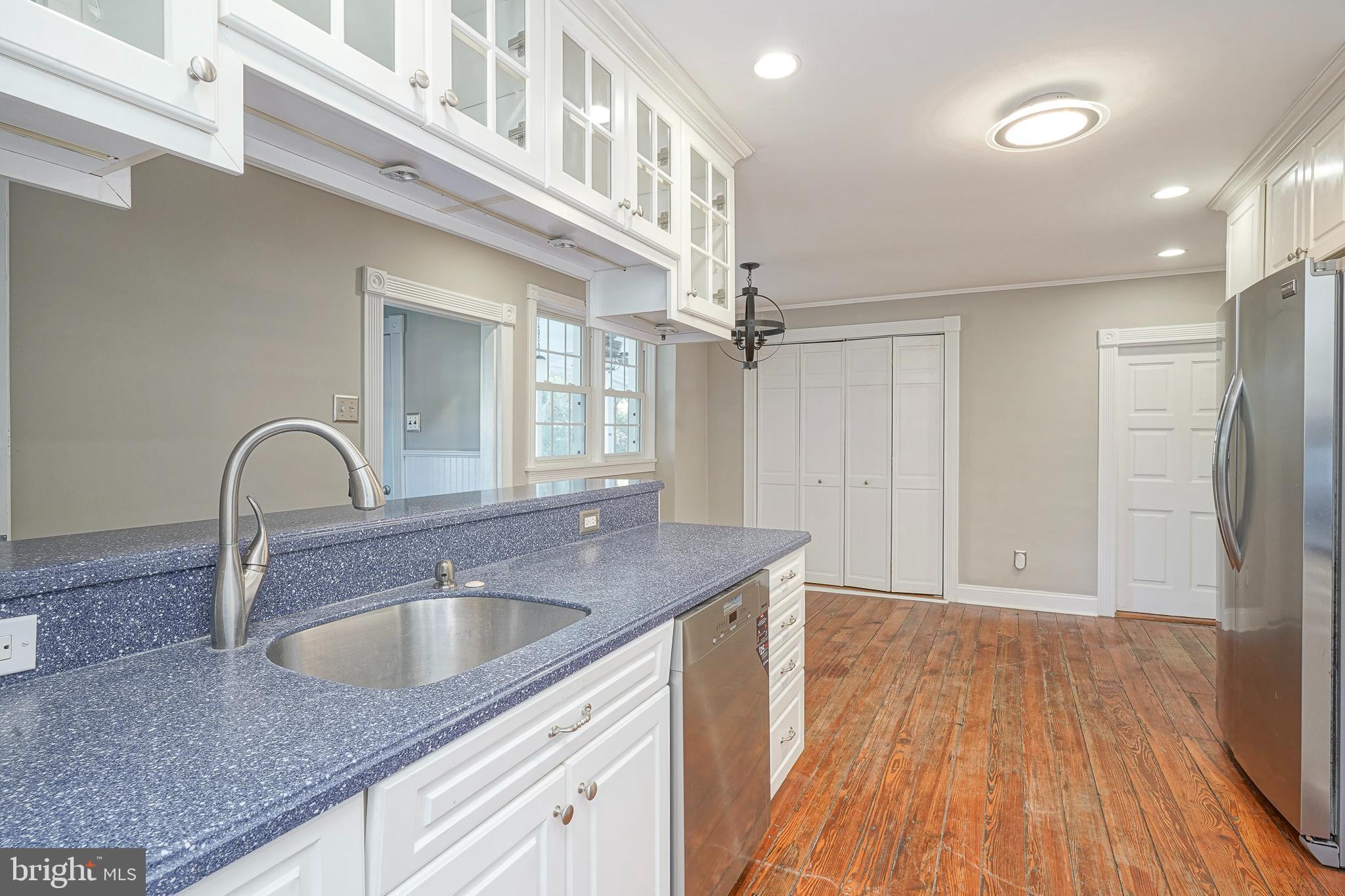 53 Branch Street Medford, NJ 08055 - Photo 17 of 41 a kitchen with stainless steel appliances granite countertop a sink a refrigerator and wooden floors