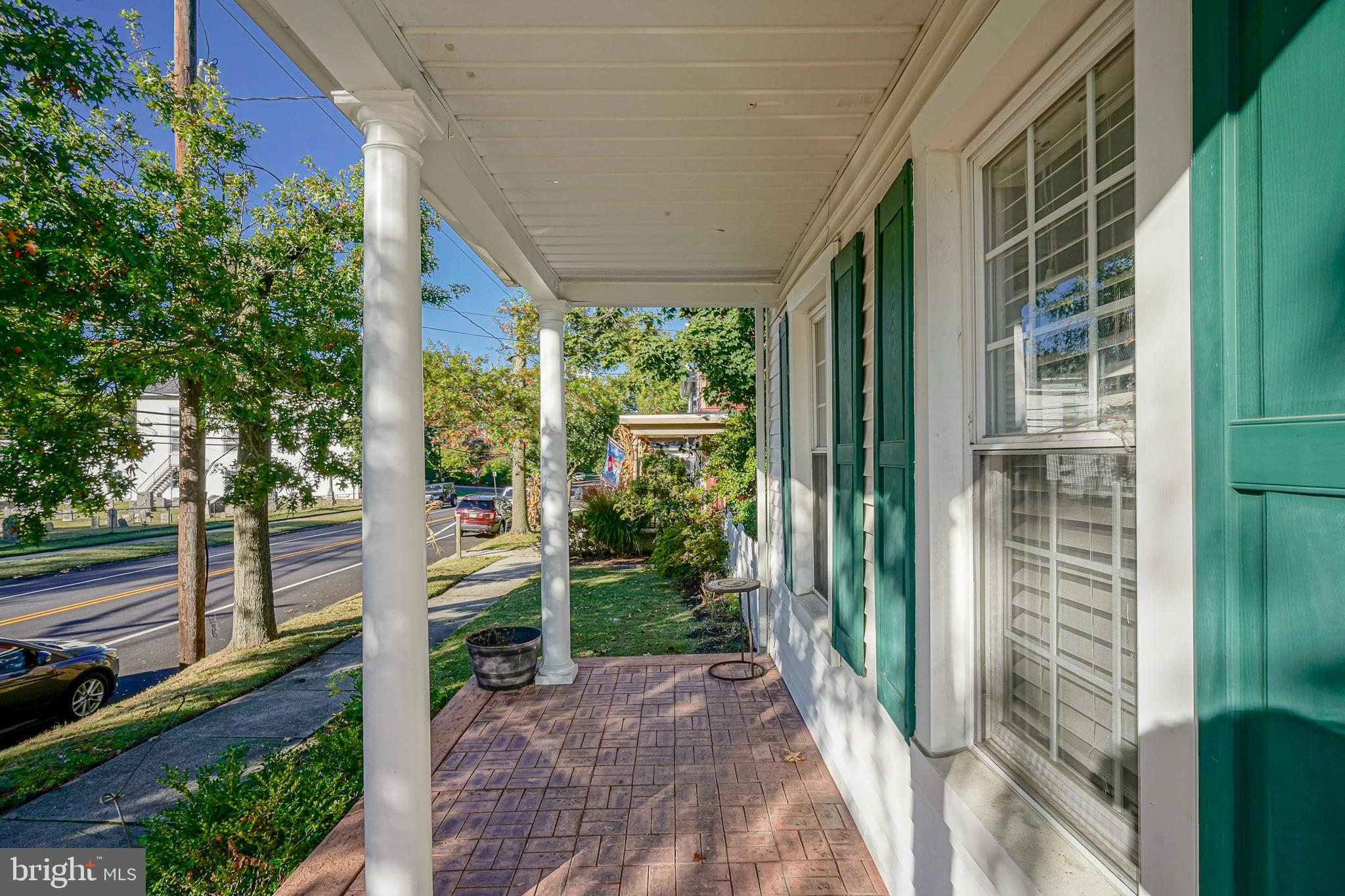 53 Branch Street Medford, NJ 08055 - Photo 3 of 41 a view of a porch with a floor to ceiling window and wooden fence