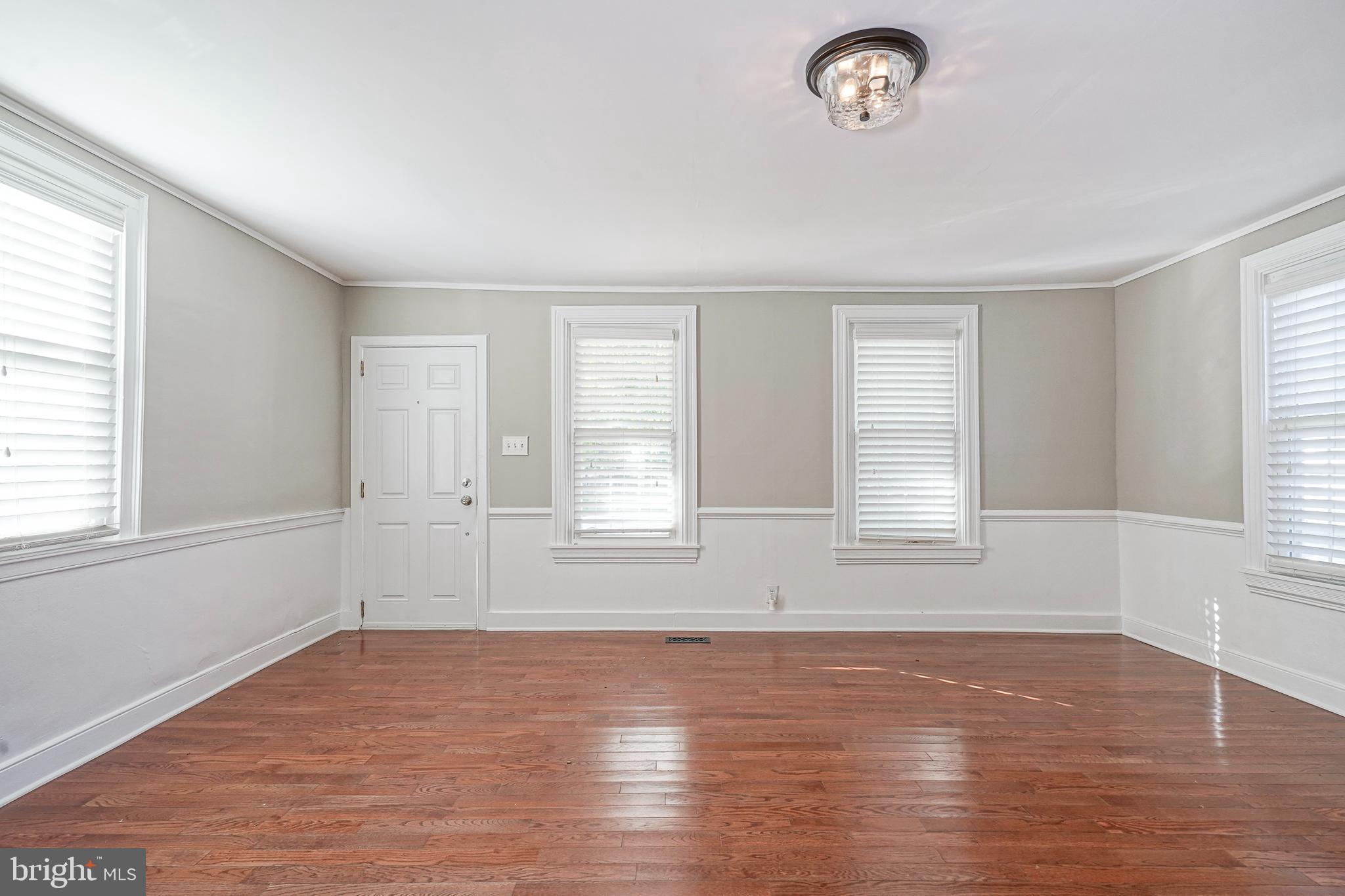 53 Branch Street Medford, NJ 08055 - Photo 4 of 41 an empty room with wooden floor and windows