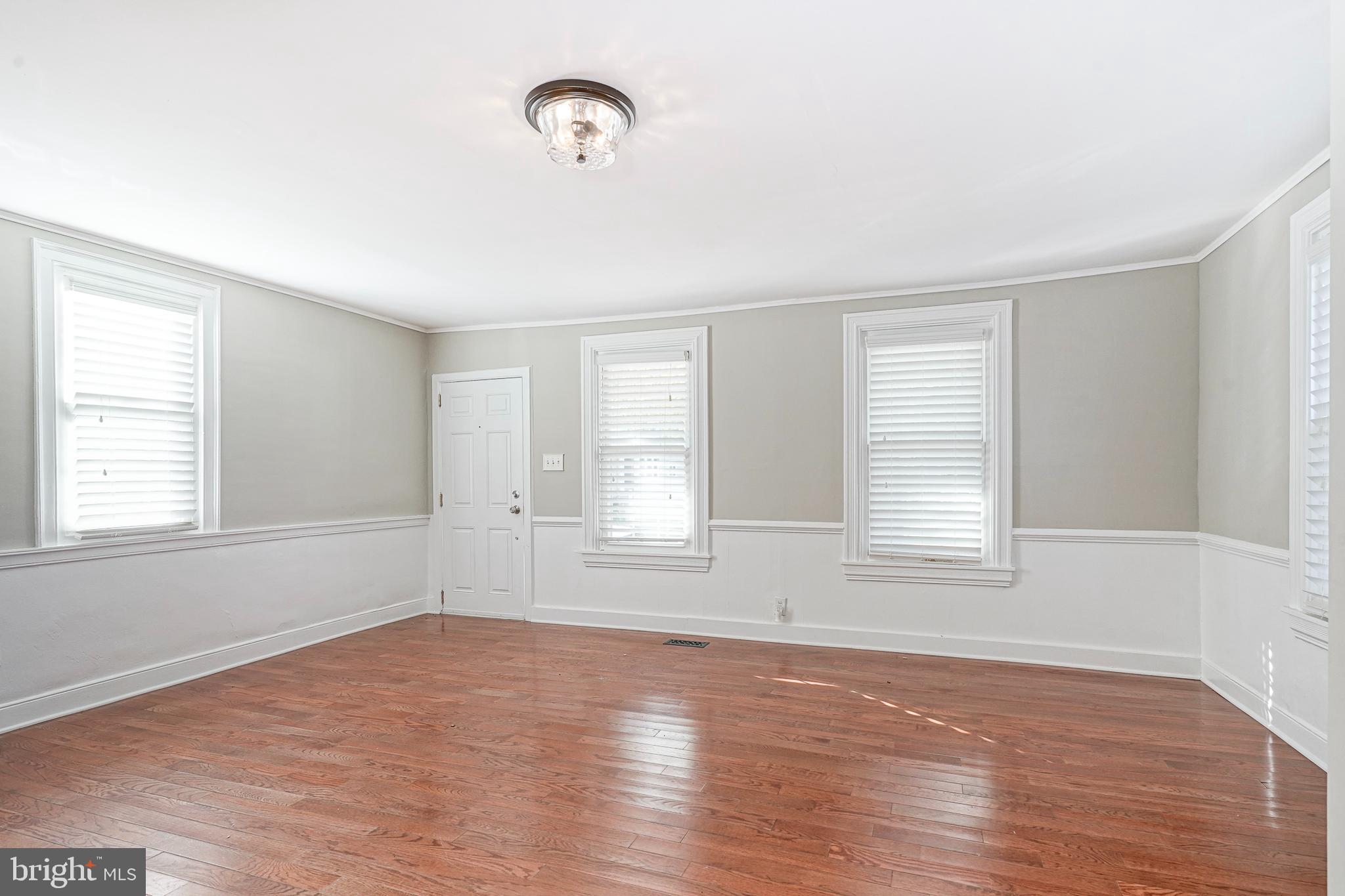 53 Branch Street Medford, NJ 08055 - Photo 5 of 41 an empty room with wooden floor and windows