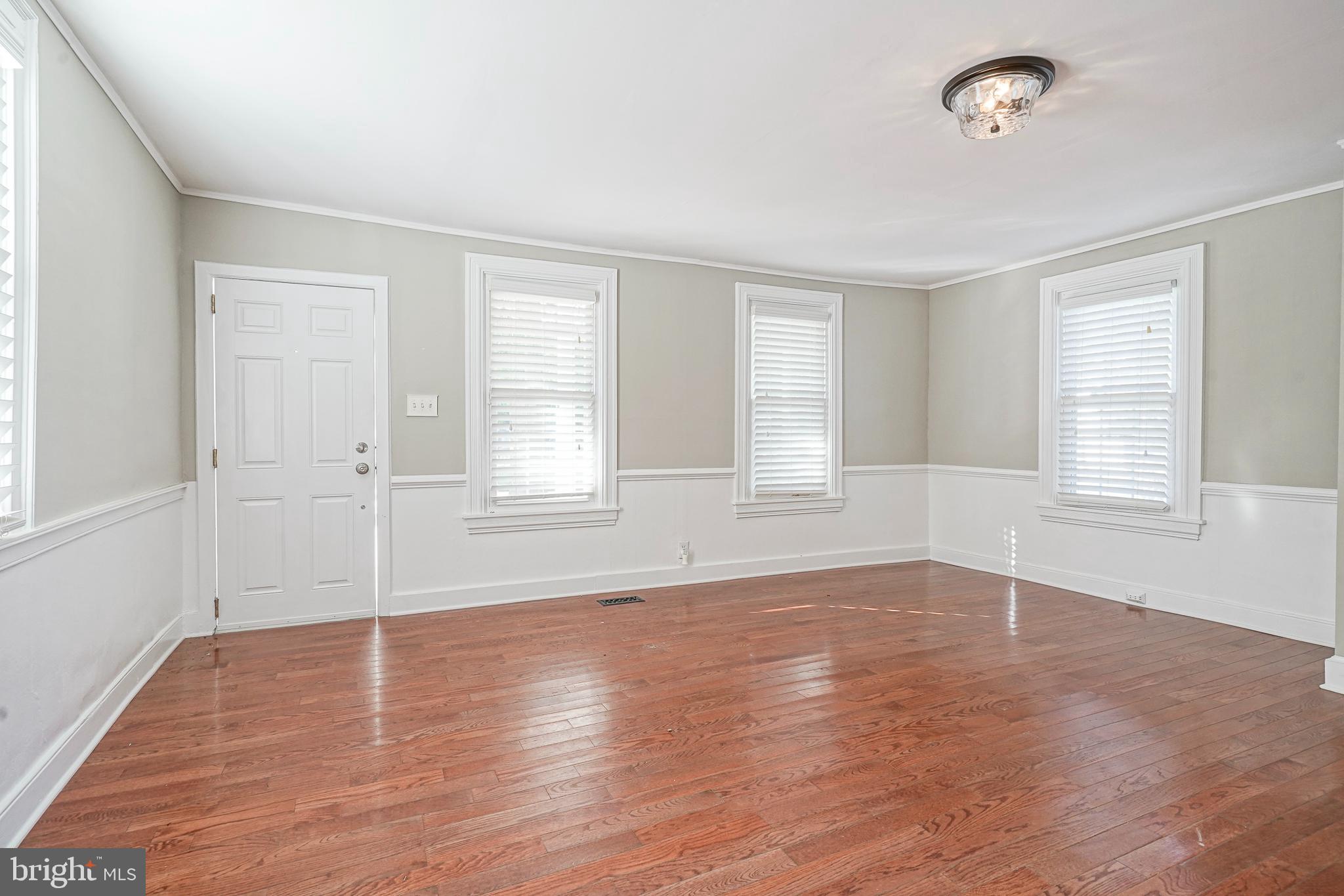 53 Branch Street Medford, NJ 08055 - Photo 6 of 41 an empty room with wooden floor and windows