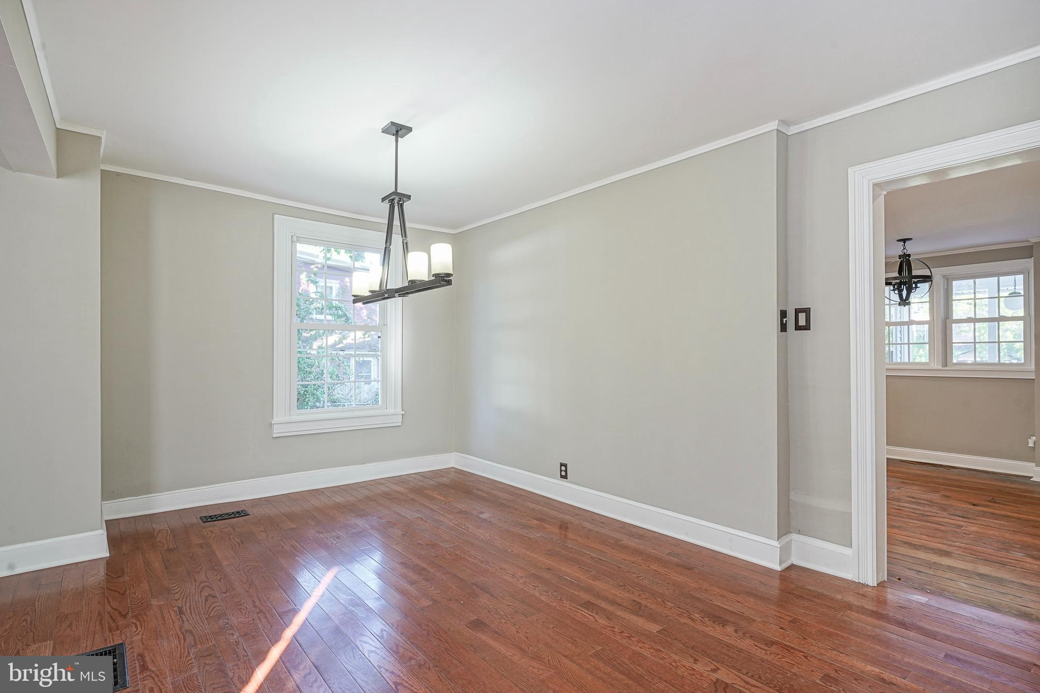 53 Branch Street Medford, NJ 08055 - Photo 10 of 41 an empty room with wooden floor chandelier and windows