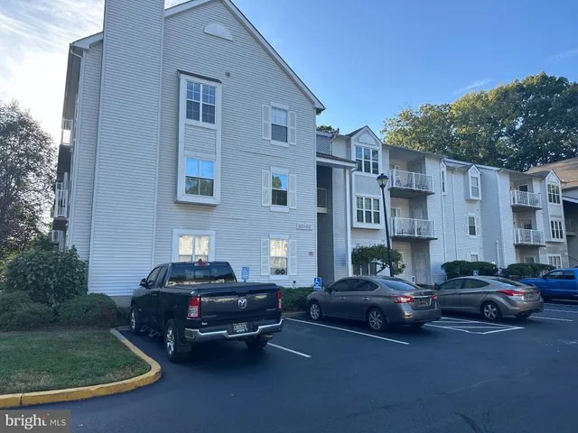 a car parked in front of a brick house