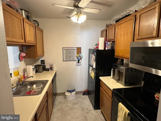 a kitchen with a refrigerator stove and sink
