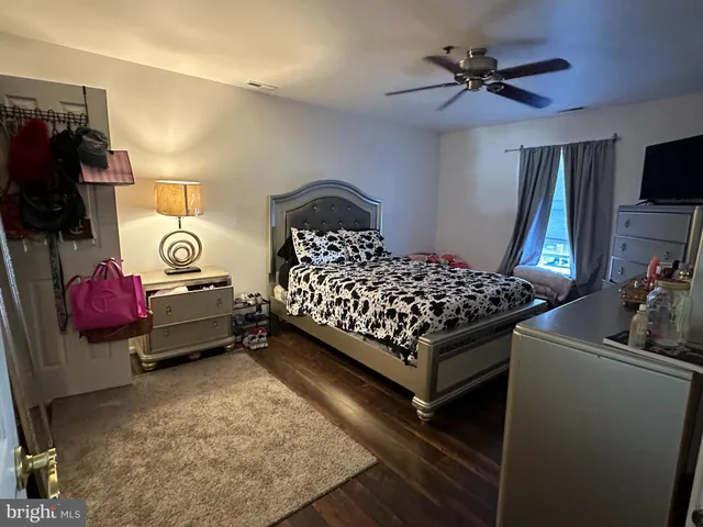 a bedroom with a bed and a tv on the dresser