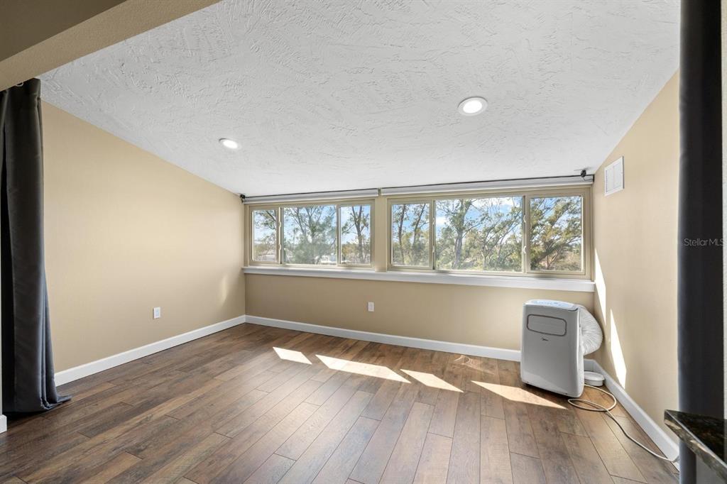 9604 Cortez Road West, Unit 136 Bradenton, FL 34210 - Photo 21 of 39 an empty room with wooden floor and windows