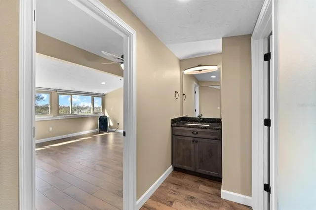 a view of a hallway view with wooden floor and staircase