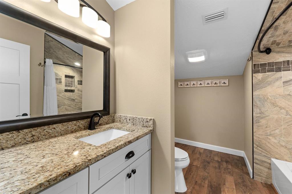 9604 Cortez Road West, Unit 136 Bradenton, FL 34210 - Photo 25 of 39 a bathroom with a granite countertop sink and a mirror